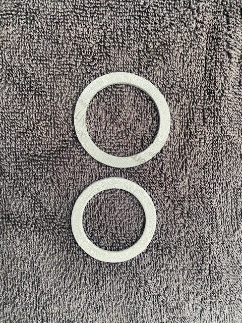 Super Duty 455 distributor gasket next to stock Pontiac distributor gasket